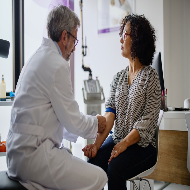 Patient having an iron infusion by a clinician